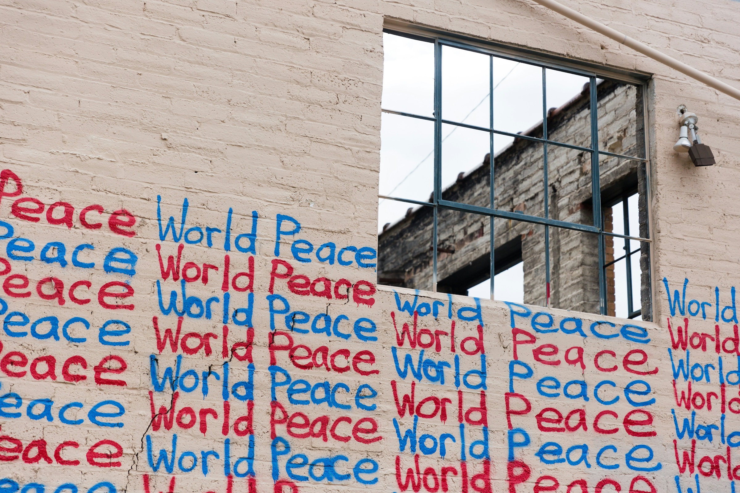 Wall with writing of "World Peace" in blue and red